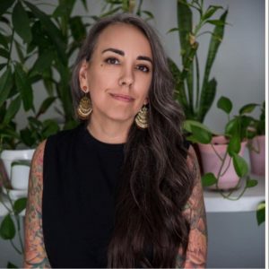 profile picture of a woman with gray and black hair smiling