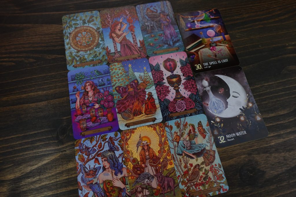Tarot and oracle cards laid in a spread on a wooden table